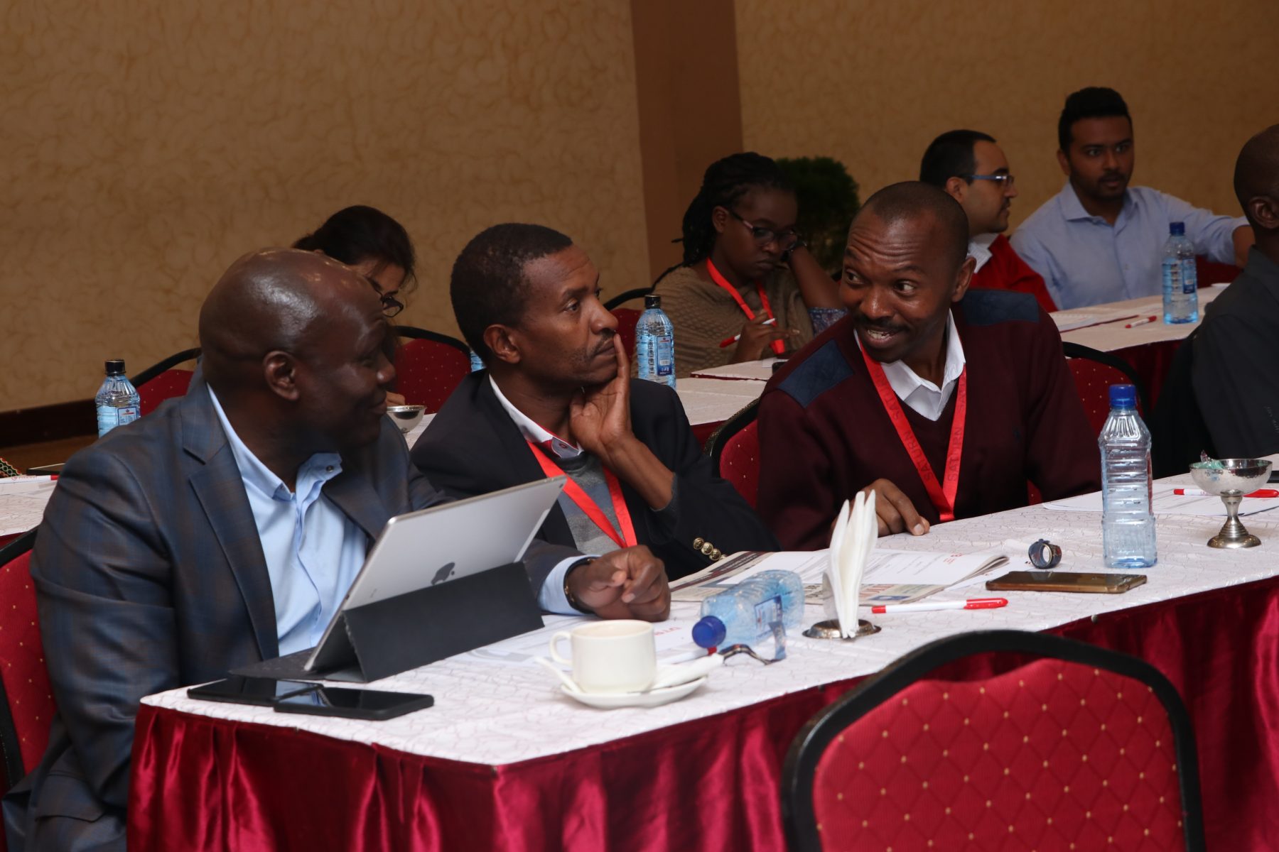 DTB General Manager and Head of Business Kennedy Nyakomitta engages with traders Vincent Kabiru of Nanap Ventures and Insurance Agency and Peter Kimani of Homeland Insurance Brokers Ltd during the DTB MSME Financial Literacy Training Programme held in Nairobi.
